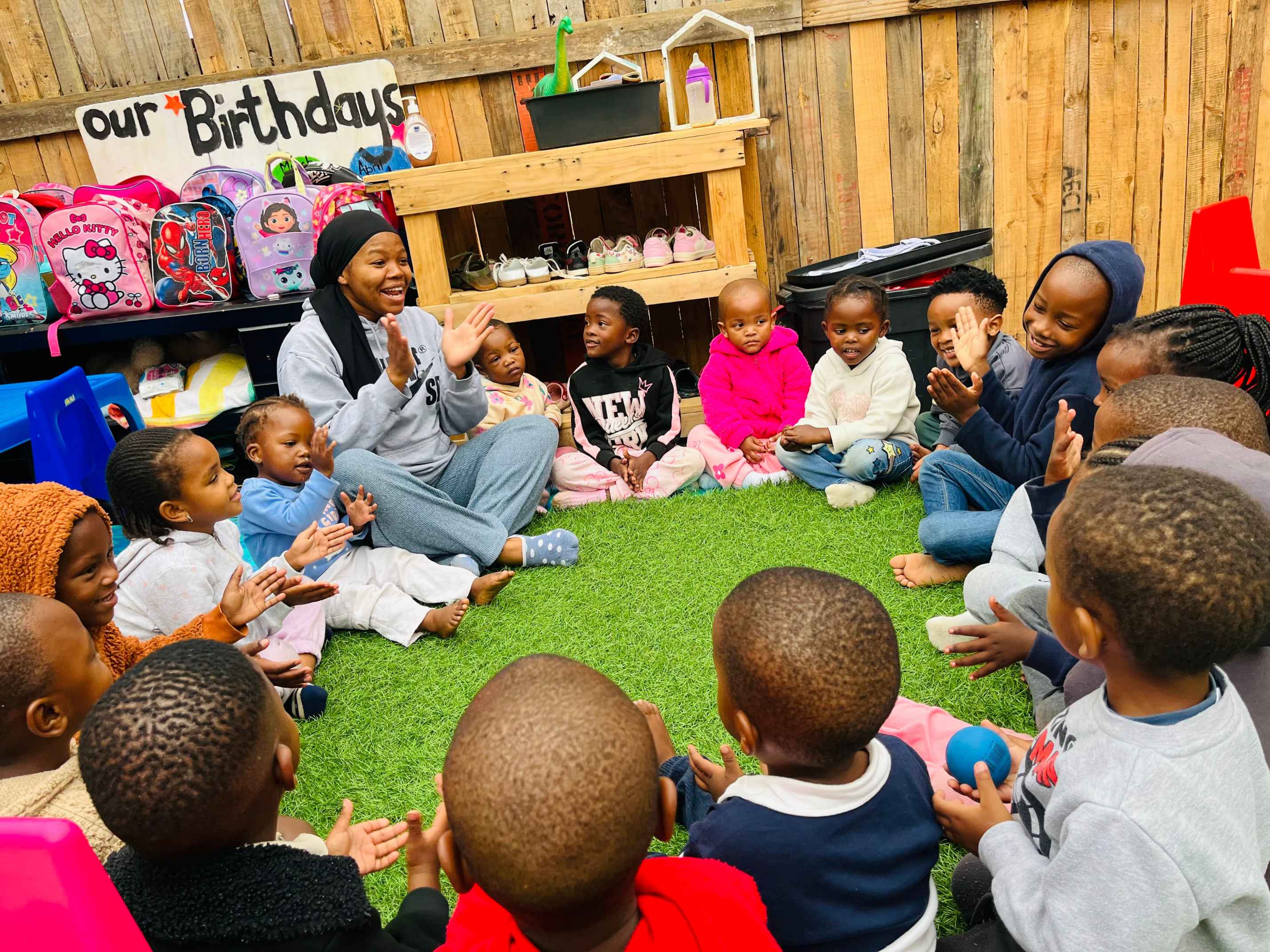 Children sitting together during a Munchkins Daycare group activity