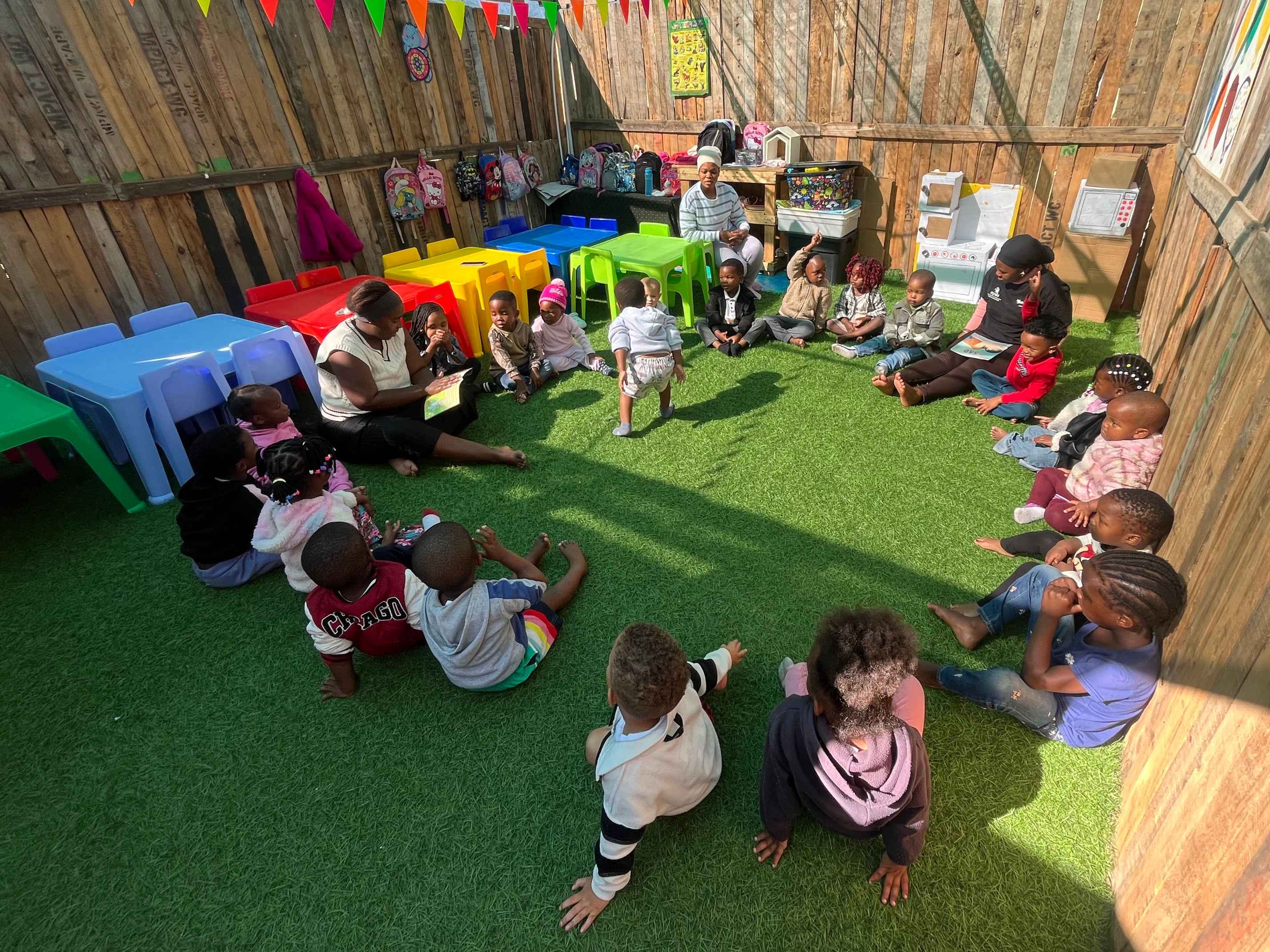Children gathered in the outdoor play area